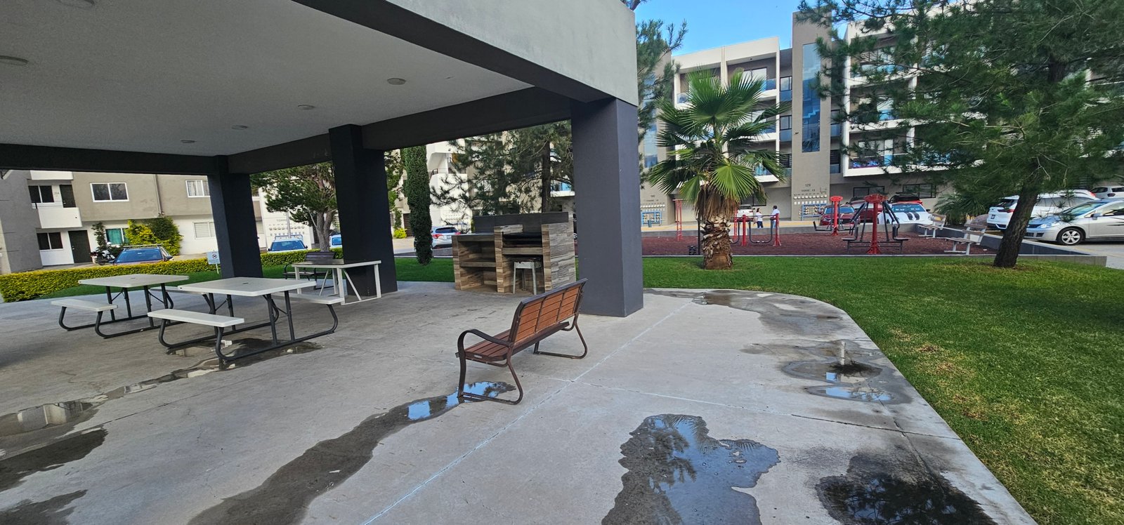 Área recreativa con bancos y parrilla en zona residencial de León