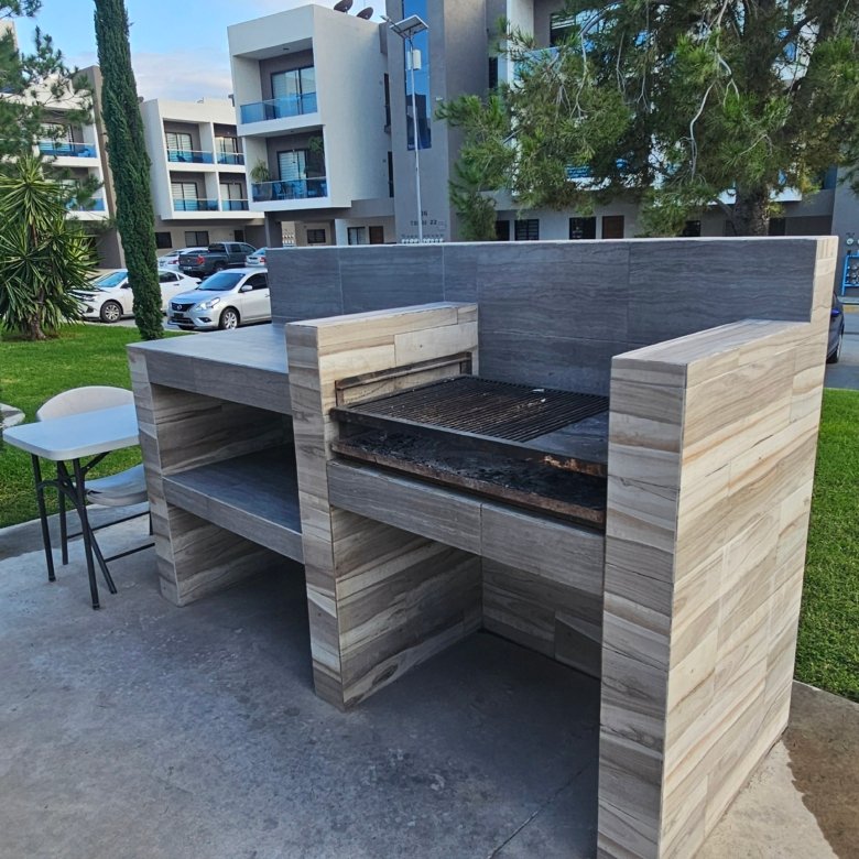 Asador moderno en área verde de departamento en venta en Rubí Residencial León Guanajuato con zona de convivencia y amenidades