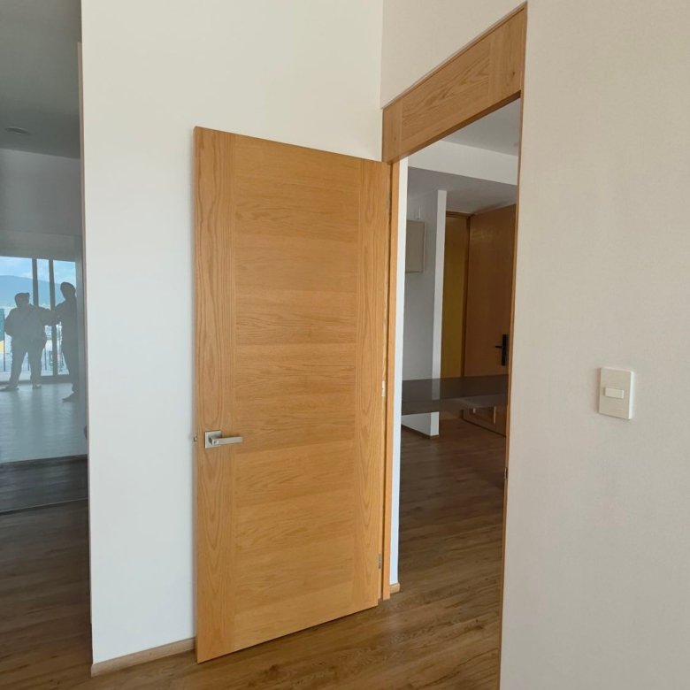 Puerta de madera en recámara moderna de departamento en renta Grand Valbuena León