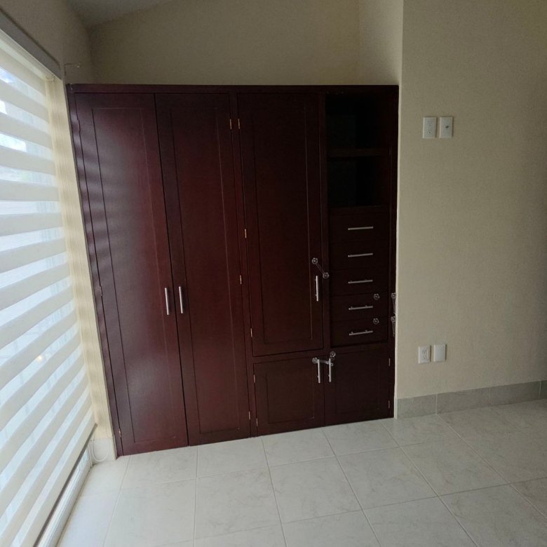 Armario y closet de madera en habitación principal de casa en renta en Larioja, El Mayorazgo Residencial, León, Gto.