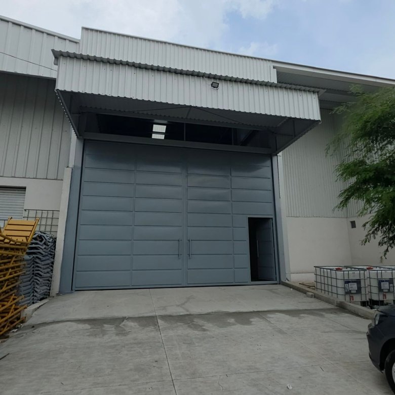 Portón de acceso vehicular y entrada de carga en bodega industrial nueva en renta en Las Joyas León Gto.